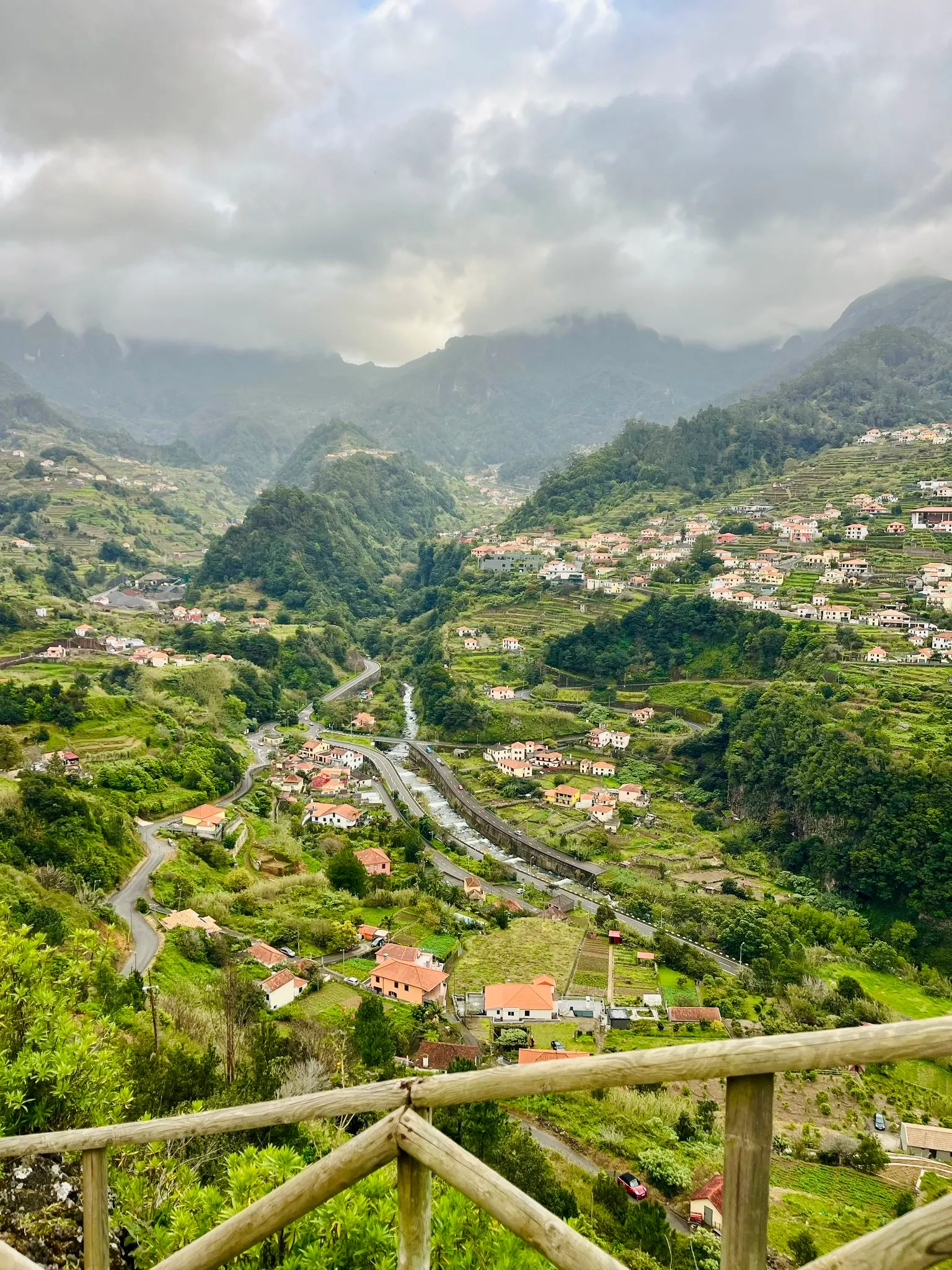 Green valley villages under low clouds in Madeira