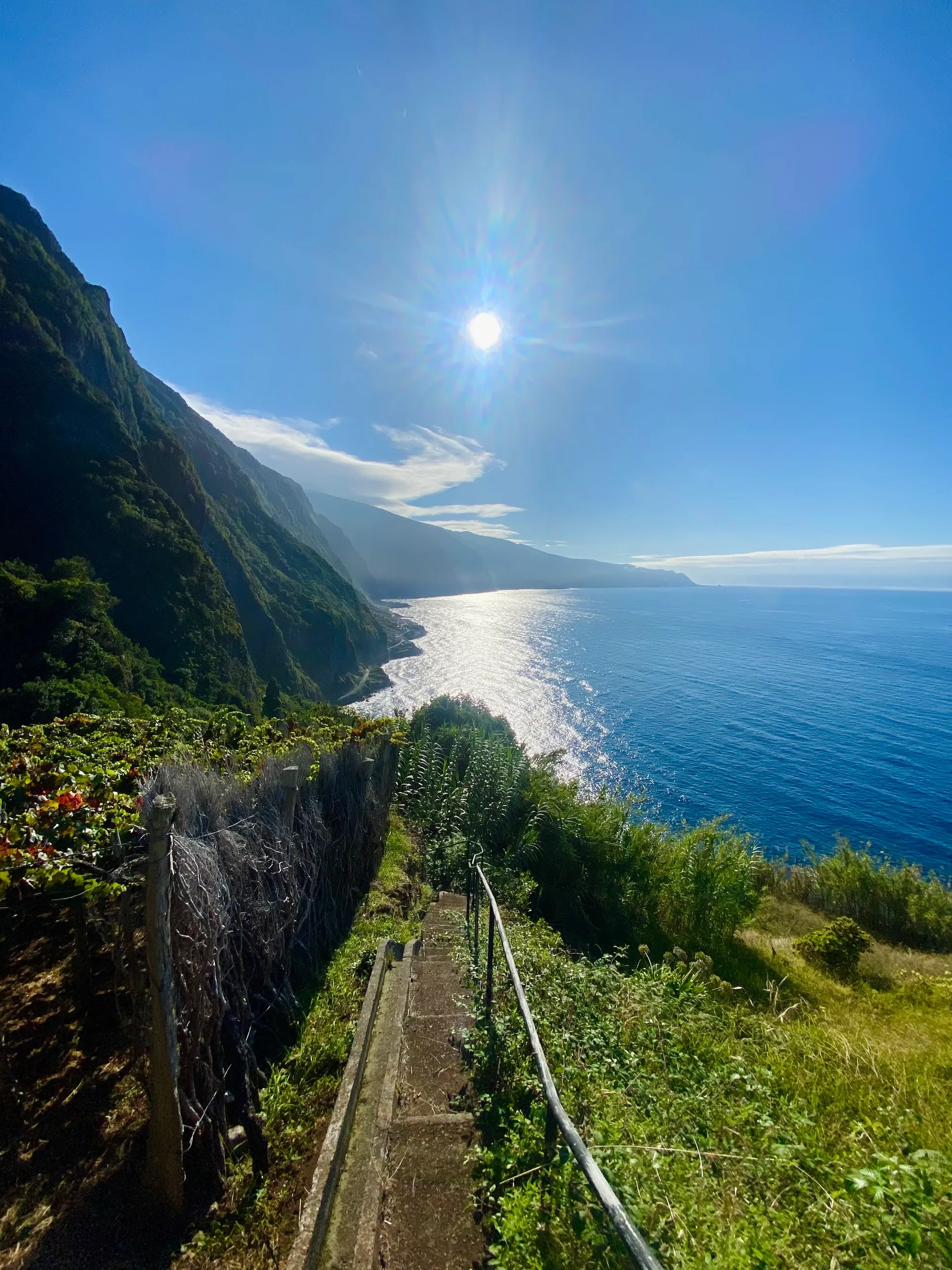 Coastal path descending toward the Atlantic in Madeira