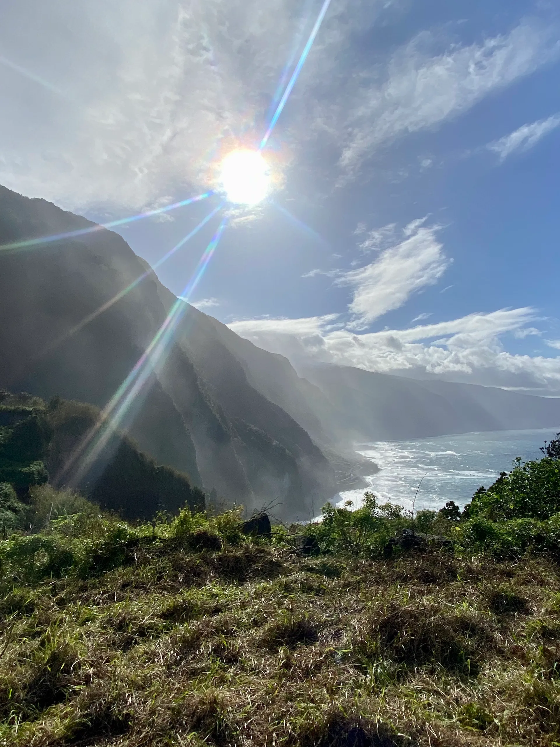 Sunlit cliffs and ocean mist on the Madeira coast